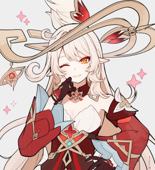 1girl alice_(genshin_impact) blonde_hair brown_gloves commentary_request cowlick detached_sleeves dress elf genshin_impact gloves gold_halo grey_background highres itsumiruka jewelry long_hair one_eye_closed orange_eyes pointy_ears pyro_symbol_(genshin_impact) red_dress red_sleeves ring side_ahoge simple_background smile solo star_(symbol) very_long_hair