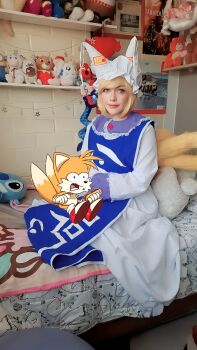 Rule 34 | 1girl, absurdres, bed, blonde hair, chili dog, cosplay, cosplay photo, fox, fox tail, gen 1 pokemon, highres, kitsune, kyuubi, lilo &amp; stitch, multiple tails, ninetales, non-web source, on bed, photo (medium), sonic (series), stitch (lilo &amp; stitch), stuffed animal, stuffed toy, tail, tails (sonic), touhou, yakumo ran, yakumo ran (fox)