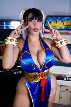 Rule 34 | 1girl, alternate color, alternate costume, blue dress, bracelet, braid, breasts, capcom, chilean (nationality), chun-li, chun-li (cosplay), cleavage, cosplay, curvy, dress, highres, indoors, interior, jewelry, large breasts, long hair, looking to the side, missyle fg, official alternate costume, parted lips, photo (medium), real life, revealing clothes, shiny clothes, shiny skin, short dress, simple background, skin tight, smile, spiked bracelet, spikes, standing, street fighter, street fighter iv (series), street fighter v, thick thighs, thighs, v, very long hair, wide hips