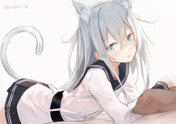 1girl absurdres animal_ears black_sailor_collar black_skirt blue_eyes cat_ears cat_tail cowboy_shot dress extra_ears grey_hair hibiki_(kancolle) highres kantai_collection koshka_pic lying on_stomach pillow pleated_dress sailor_collar sailor_shirt school_uniform serafuku shirt simple_background skirt solo tail verniy_(kancolle) white_background white_shirt