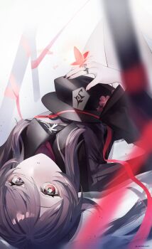1girl black_nails brown_coat brown_hair bug butterfly chinese_clothes coat flower flower-shaped_pupils genshin_impact hat hat_flower hat_on_chest highres hu_tao_(genshin_impact) insect jewelry knees_up light_particles long_hair looking_at_viewer lying multiple_rings on_back parted_lips plum_blossoms porkpie_hat red_butterfly red_eyes ribbon ring sidelocks solo symbol-shaped_pupils twitter_username upside-down white_background yukiusagi_(snowrabbit0508)