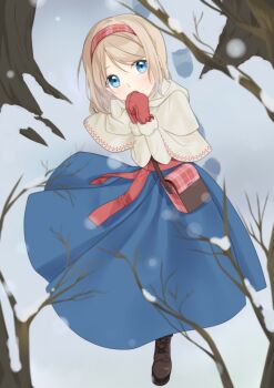 1girl alice_margatroid bag bare_tree blonde_hair blue_dress blue_eyes boots brown_boots capelet commentary_request dress footprints hairband highres lace-up_boots long_sleeves looking_at_viewer medium_hair mittens outdoors pink_hairband red_mittens red_sash sash scarf shoulder_bag snow snowing solo touhou tree tsuno_no_hito waist_sash white_capelet white_scarf winter
