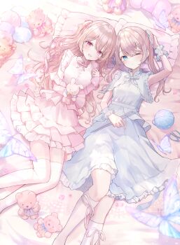 2girls :d blue_bow blue_bowtie blue_dress blue_eyes blush bow bowtie brown_hair closed_mouth commentary_request detached_sleeves dress feet_out_of_frame frilled_dress frills highres irono1910 long_hair long_sleeves looking_at_viewer lying multiple_girls on_back one_eye_closed open_mouth original pillow pink_bow pink_bowtie pink_dress pink_sleeves red_eyes sleeveless sleeveless_dress smile socks stuffed_animal stuffed_toy teddy_bear thighhighs white_socks white_thighhighs