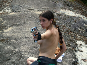 1girl braid breasts brown_eyes brown_hair cosplay female_focus gloves gun lara_croft looking_back photo_(medium) real_life solo tanya_sochivets tomb_raider topless_female weapon