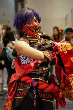 1girl armor asymmetrical_clothes black_gloves black_hair blurry blurry_background chest_sarashi cosplay cosplay_photo crossed_arms gloves hair_between_eyes hakama hakama_pants highres japanese_clothes mask matching_hair/eyes mercyuyu mouth_mask multicolored_hair namco official_alternate_costume pants photo_(medium) purple_eyes purple_hair real_life reina_(tekken) reina_(tekken)_(cosplay) sarashi short_hair shoulder_armor solo_focus tekken tekken_8 two-tone_hair