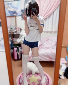 1girl asian bare_arms black_hair blurry blurry_background cell clothes_writing contrapposto full_body hair_ornament highres indoors japanese_text medium_hair one_side_up photo_(medium) real_life selfie short_hair short_shorts short_sleeves shorts skindentation solo solo_focus source_request thighhighs thighs v white_thighhighs