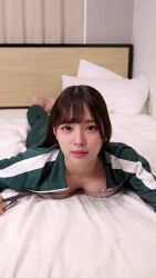 1girl animated asian bra breasts brown_hair highres indoors long_hair looking_at_viewer lying medium_breasts on_stomach pjms_miku real_life removing_bra solo squid_game tagme underwear undressing unworn_bra video