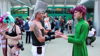 2boys 2girls animated aqua_hair arm_tattoo bandages bikini black_bikini blood_on_clothes bracelet convention cosplay crowd dark_magician_girl earrings elfen_lied flattop goggles green_jacket grey_hair gun highres jacket jean_pierre_polnareff jewelry jojo_no_kimyou_na_bouken kakyoin_noriaki lucy_(elfen_lied) multiple_boys multiple_girls naked_bandage outdoors pink_hair real_life rifle school_uniform sinon sniper_rifle swimsuit sword_art_online tagme tattoo video weapon yu-gi-oh!