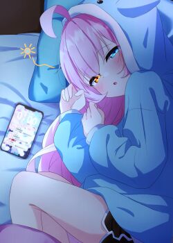 1girl ahoge animal_ear_hood black_shorts blue_archive blue_eyes blue_hoodie blush cellphone character_print commentary_request dolphin_shorts fake_animal_ears feet_out_of_frame heterochromia highres hood hood_up hoodie hoshino_(blue_archive) indoors knees_up long_hair long_sleeves looking_at_viewer lying on_bed on_side orange_eyes phone photo_(object) pink_hair puffy_long_sleeves puffy_sleeves shorts sleepy smartphone solo squeans tears u9ffo very_long_hair yume_(blue_archive)