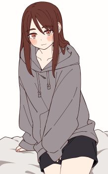 1girl absurdres between_legs black_shorts blush brown_eyes brown_hair closed_mouth collarbone drawstring hair_between_eyes highres hood hood_down hoodie kapatarou long_hair long_sleeves looking_at_viewer original oversized_clothes short_shorts shorts sitting sleeves_past_wrists solo