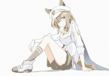 1girl animal_ears ascot black_shorts black_socks blue_cape blue_eyes blush breasts brown_hair cape cheval_grand_(grand_itineraire)_(umamusume) cheval_grand_(umamusume) closed_mouth ear_covers ears_through_headwear gloves hair_between_eyes hakugitsu hat hat_belt highres horse_ears horse_girl horse_tail jacket long_hair looking_at_viewer multicolored_hair peaked_cap shoes shorts simple_background single_glove sitting smile socks solo streaked_hair tail umamusume white_background white_hair white_hat white_jacket yellow_ascot