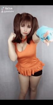 Rule 34 | 1girl, animated, animated gif, breasts, brown hair, cleavage cutout, clothing cutout, cosplay, crossed arms, diane (nanatsu no taizai), diane (nanatsu no taizai) (cosplay), gloves, large breasts, long hair, nanatsu no taizai, photo (medium), real life, shorts, single glove, sleeveless, tattoo, twintails, yuno the loose