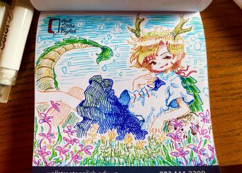 1girl absurdres antlers art_tools_in_frame blonde_hair blue_shirt blue_skirt commentary_request dragon_girl dragon_horns dragon_tail fur-tipped_tail green_scales green_tail highres horns kicchou_yachie looking_at_viewer open_mouth photo_(medium) shirt short_sleeves skirt smile solo spiked_shell suteruko tail touhou traditional_media turtle_shell yellow_eyes yellow_horns