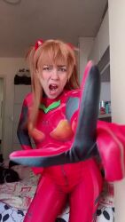 1girl angry animated ass bodysuit brazilian_(nationality) cat cosplay female_focus green_eyes index_finger_raised indoors long_hair looking_at_viewer lowres mecha_pilot_suit meme neon_genesis_evangelion nerokosplayer open_mouth orange_hair photo_(medium) plugsuit_(evangelion) pointing pointing_at_viewer real_life red_bodysuit solo sound souryuu_asuka_langley tsundere video