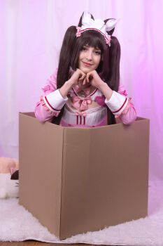 Rule 34 | 1girl, absurdres, animal ears, bell, bow, box, brown eyes, brown hair, buttons, cardboard box, cat ears, cat girl, chocola (nekopara), chocola (nekopara) (cosplay), collar, cosplay, dress, female focus, heart, heart button, heart hands, highres, in box, in container, indoors, long sleeves, looking at viewer, maid, maid headdress, nekopara, photo (medium), pink bow, pink dress, red trim, smile, solo, stelarhoshi, twintails