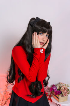 Rule 34 | 1girl, absurdres, black bow, black hair, black skirt, blunt bangs, bow, box, cosplay, cosplay photo, cowboy shot, fate (series), female focus, flower, hair bow, hands on own face, hands up, highres, indoors, long hair, long sleeves, looking at viewer, parted lips, photo (medium), pleated skirt, purple flower, red sweater, skirt, solo, stelarhoshi, sweater, table, tohsaka rin, tohsaka rin (cosplay), twintails, wide-eyed