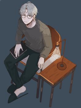 1boy black_pants black_slippers book brown_eyes chair closed_mouth curtained_hair desk_lamp from_above full_body galiumnightride glasses grey-framed_eyewear grey_background grey_hair grey_sweater highres hitotsubashi_ayato hitotsubashi_ayato_(2nd_costume) holding holding_book lamp long_sleeves looking_at_viewer male_focus nijisanji on_chair pants short_hair simple_background sitting slippers solo sweater table undercut virtual_youtuber