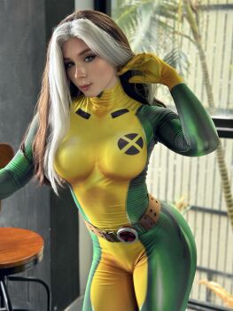 1girl bodysuit breasts brown_hair cosplay cosplay_photo female_focus green_bodysuit marvel marvel_rivals medium_breasts multicolored_bodysuit multicolored_hair photo_(medium) photo_(object) real_life rogue_(x-men) rogue_(x-men)_(cosplay) solo superhero_costume sweetie_fox two-tone_bodysuit two-tone_hair white_hair x-men yellow_bodysuit