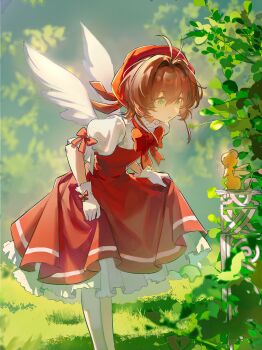1girl :o absurdres antenna_hair bow brown_hair cardcaptor_sakura child chinese_commentary commentary_request donghuarendonghuahun dress gloves green_eyes hat highres kero_(cardcaptor_sakura) kinomoto_sakura kinomoto_sakura_(magician) leaf magical_girl open_mouth outdoors pantyhose puffy_short_sleeves puffy_sleeves red_bow red_dress red_hat short_hair short_sleeves skirt_hold solo_focus white_gloves white_pantyhose wings