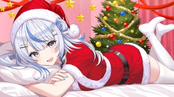 1girl blue_hair capelet christmas_tree commentary_request dress grey_hair hat highres indie_virtual_youtuber indoors looking_at_viewer lying mixed-language_commentary multicolored_hair on_stomach open_mouth pillow red_capelet red_dress red_hat santa_costume santa_hat second-party_source shiozora_namiri smile solo streaked_hair sunamama4788 the_pose thighhighs virtual_youtuber white_thighhighs zettai_ryouiki