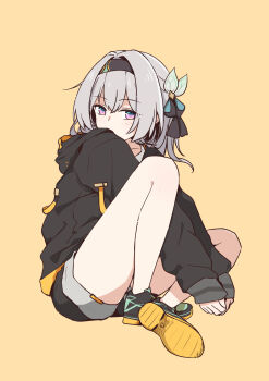 1girl absurdres alternate_costume bare_legs black_hairband black_jacket black_ribbon black_shoes black_shorts blue_pupils blush commentary_request covering_own_mouth firefly_(honkai:_star_rail) grey_hair hair_between_eyes hair_intakes hair_ornament hair_ribbon hairband highres honkai:_star_rail honkai_(series) jacket knee_up legs long_hair long_sleeves looking_at_viewer multicolored_eyes own_hands_together ribbon shoes shorts simple_background sitting solo tabitsuki yellow_background