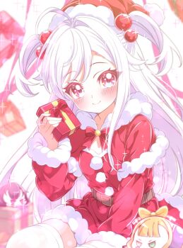 1girl antenna_hair blurry blush box christmas closed_mouth commentary_request depth_of_field fur_trim gift gift_box hair_bobbles hair_ornament hat highres holding kanaria_chick kathrina_griebel long_hair long_sleeves looking_at_viewer niizuma_yae santa_costume santa_hat sitting smile solo thighhighs world_dai_star