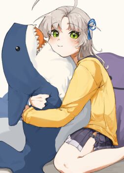 1girl antenna_hair breasts cardigan commentary_request feet_out_of_frame green_eyes grey_hair hirg558899 hugging_doll hugging_object ikea_shark kantai_collection kinugasa_(kancolle) kinugasa_kai_ni_(kancolle) medium_breasts pleated_skirt purple_skirt sitting skirt solo stuffed_animal stuffed_shark stuffed_toy wariza yellow_cardigan