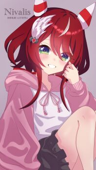 1girl absurdres animal_ears blush breasts commentary_request ear_covers ear_ornament feather_hair_ornament feathers galanthus green_eyes hair_between_eyes hair_ornament highres hood hood_down hoodie horse_ears horse_girl long_hair looking_at_viewer low_twintails open_mouth pink_hood pink_sleeves pleated_skirt red_hair simple_background skirt small_breasts smile solo twintails umamusume white_hoodie win_variation_(umamusume)