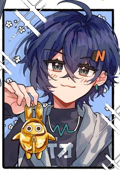 1girl :3 ahoge belle_(zenless_zone_zero) black_border black_shirt blue_background blue_hair blush border closed_mouth commentary crossed_bangs earclip earrings english_commentary floral_print golden_bangboo green_eyes hair_between_eyes hair_ornament hand_up head_tilt highres holding jewelry letter_hair_ornament looking_at_viewer necklace portrait print_shirt shirt short_hair solo sshooooe zenless_zone_zero