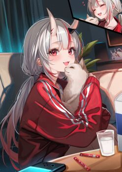 1girl :d cat center-flap_bangs commentary_request couch cup drink_carton fang gradient_hair grey_hair hair_between_horns highres holding hololive horns indoors jacket long_hair looking_at_viewer low_twintails milk milk_carton multicolored_hair nakiri_ayame nakiri_ayame_(cutie_jersey) nintendo_switch_2 official_alternate_costume on_couch oni open_mouth poyoyo_(nakiri_ayame) red_eyes red_hair red_jacket sa-ya2 shirt sitting skin-covered_horns skin_fang smile solo streaked_hair twintails virtual_youtuber white_shirt zir_(nakiri_ayame)