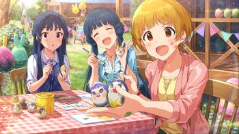3girls :d black_hair blonde_hair blue_hair brown_eyes card_commentary chair commentary_request day earrings egg egg_painting fukuda_noriko game_asset glint holding holding_egg idolmaster idolmaster_million_live! idolmaster_million_live!_theater_days jewelry kitakami_reika long_hair looking_at_viewer mogami_shizuka multiple_girls official_art on_chair open_clothes open_mouth open_shirt outdoors pink_shirt shirt short_hair sitting smile table third-party_source twintails_with_hair_base wooden_chair