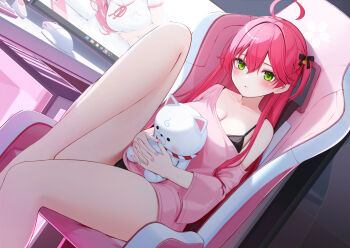 1girl 35p_(sakura_miko) ahoge black_bra black_panties bow bra bra_peek breasts chair cleavage commentary_request computer_mouse double-parted_bangs dutch_angle gaming_chair green_eyes hair_bow holding holding_stuffed_toy hololive indoors knee_up large_breasts long_hair looking_at_viewer monitor no_pants nyan_(reinyan_007) on_chair one_side_up panties panty_peek pink_hair pink_shirt sakura_miko shirt single_off_shoulder sitting solo stuffed_animal stuffed_toy swivel_chair three-quarter_sleeves underwear virtual_youtuber