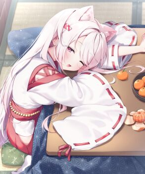 1girl animal_ears cat_ears commentary food fruit gradient_hair hair_ornament hairclip hakama hakama_skirt highres indoors japanese_clothes kotatsu ksk_(semicha_keisuke) long_hair looking_at_viewer mandarin_orange miko multicolored_hair nijisanji one_eye_closed open_mouth pink_eyes pink_hair ribbon-trimmed_sleeves ribbon_trim shiina_yuika shiina_yuika_(3rd_costume) sidelocks sitting skirt solo table under_kotatsu under_table virtual_youtuber white_hair