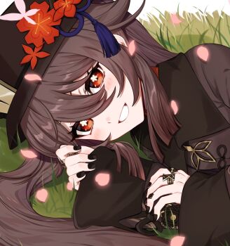 1girl black_hat black_nails blush brown_hair chinese_clothes commentary_request eyelashes flower flower-shaped_pupils genshin_impact grass grin hair_between_eyes hat hat_ornament highres hu_tao_(genshin_impact) long_hair long_sleeves looking_at_viewer lying nail_polish on_side plum_blossoms porkpie_hat red_eyes sidelocks smile solo sushi_171 symbol-shaped_pupils teeth thumb_ring two_side_up