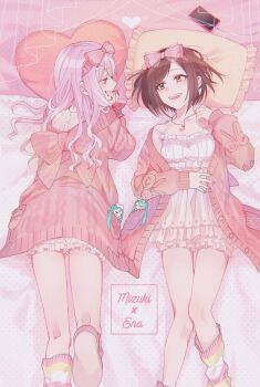 2girls akiyama_mizuki bow brown_hair cardigan cellphone dress frills hair_bow heart heart-shaped_pillow jewelry long_hair lying multiple_girls necklace on_back on_bed on_stomach open_mouth phone pillow pink_hair project_sekai shinonome_ena short_hair smile socks striped