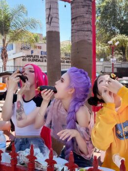 3girls arm_tattoo black_hair bottle bracelet braid building cosplay earrings eating eyeshadow foil food food_in_mouth highres jewelry korean_(nationality) kpop_demon_hunters long_hair makeup makizushi mira_(kpop_demon_hunters) multiple_girls outdoors photo_(medium) pig_tail pine_tree pink_hair plate purple_hair real_life ring rumi_(kpop_demon_hunters) sushi table tail tattoo tree water_bottle zoey_(kpop_demon_hunters)