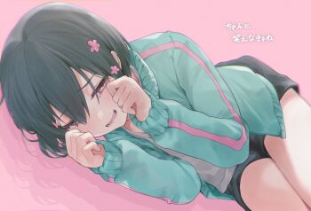 1girl :d absurdres black_hair black_shorts cha_komugi chromatic_aberration commentary_request cowboy_shot flower green_jacket hair_flower hair_ornament highres iyowa_girls jacket kurari-chan_(iyowa) kyu-kurarin_(cevio) lying lyrics narrowed_eyes on_side open_clothes open_jacket open_mouth pink_background pink_eyes pink_flower sad_smile shadow shirt short_hair shorts simple_background smile solo track_jacket translation_request white_shirt