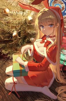1girl absurdres animal_ear_hairband animal_ears blonde_hair blue_archive blue_eyes box breasts christmas christmas_tree cleavage dress fake_animal_ears ggoong_(pooplambgoong22) gift gift_box hairband halo hat highres kneeling looking_at_viewer medium_breasts rabbit_ear_hairband rabbit_ears santa_costume santa_dress santa_hat sitting solo thighhighs toki_(blue_archive) toki_(bunny)_(blue_archive) wariza white_thighhighs zettai_ryouiki