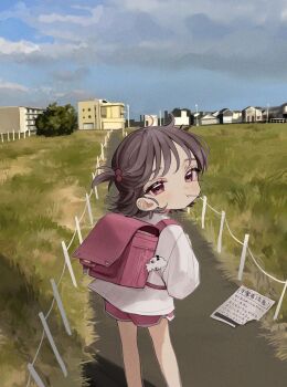 1girl artist_name backpack bag bag_charm brown_hair building candy charm_(object) child closed_mouth cloud cloudy_sky day feet_out_of_frame film_grain flyer food from_behind grass hair_bobbles hair_ornament highres house ishida_umi lollipop long_sleeves looking_at_viewer looking_back original outdoors randoseru red_eyes red_shorts road shirt short_hair shorts sky solo standing translation_request two_side_up watermark white_shirt