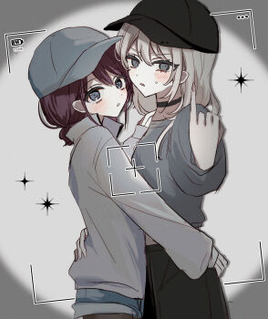 2girls absurdres baseball_cap battery_indicator black_choker black_hat blue_shorts blush brown_hair choker commentary girls_band_cry grey_eyes grey_hair grey_hat grey_shirt hair_between_eyes hamchan69 hat highres hug iseri_nina kawaragi_momoka low_twintails multiple_girls open_mouth pantyhose pantyhose_under_shorts shirt short_hair short_twintails shorts sweatdrop twintails viewfinder yuri