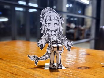 1girl box commentary corrupted_twitter_file english_commentary fins fish_tail full_body gawr_gura gift gift_box hair_ornament hat highres hololive hololive_english hood hoodie implied_futanari jqhnharqld monochrome outstretched_arms paper_child papercraft_(medium) photo_(medium) raised_eyebrows santa_hat shark_hair_ornament shark_tail smile smug solo tail two_side_up unconventional_media virtual_youtuber what