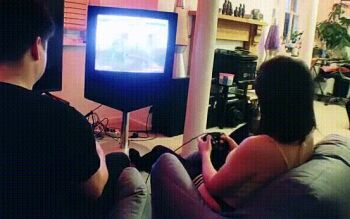 1boy 1girl all_fours animated animated_gif bare_arms bare_shoulders black_panties black_thighhighs clothed_sex clothing_aside defeat doggystyle hetero indoors instant_loss lava_lamp no_shoes panties panties_aside photo_(medium) playing_games real_life sex sex_from_behind sex_slave sitting tagme tank_top tekken thighhighs thong underwear video_game