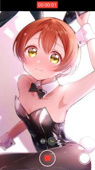 1girl animal_ears black_bow black_bowtie black_leotard black_pantyhose bow bowtie breasts brown_hair commentary_request detached_collar fake_animal_ears highres holding hoshizora_rin leotard love_live! love_live!_school_idol_project osono_(osonokichi) pantyhose playboy_bunny rabbit_ears rabbit_tail recording shadow short_hair sitting small_breasts solo strapless strapless_leotard tail user_interface wrist_cuffs yellow_eyes yokozuwari