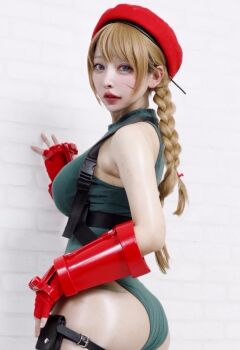 1girl ass bare_shoulders beret blonde_hair cammy_white cammy_white_(cosplay) capcom cosplay_photo female_focus fingerless_gauntlets fingerless_gloves gloves green_leotard hat highleg highleg_leotard kagamisou leotard looking_at_viewer looking_back photo_(medium) real_life red_gauntlets red_gloves red_hat scar scar_on_face solo street_fighter thigh_strap