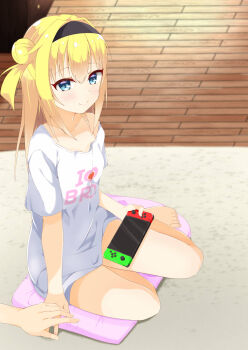 1girl 1other bare_legs barefoot black_hairband blonde_hair blue_eyes blurry blurry_background blush breasts chitose_sana closed_mouth clothes_writing collarbone commentary_request cushion english_text full_body hair_between_eyes hair_bun hair_intakes hairband handheld_game_console heart heart_print highres holding holding_handheld_game_console holding_hands indoors long_hair looking_at_viewer nintendo_switch on_cushion one_side_up oversized_clothes oversized_shirt print_shirt sakaki_asuka shirt short_sleeves sidelocks single_bare_shoulder sitting small_breasts smile solo_focus split_mouth t-shirt tenshinranman thighs toenails toes white_shirt wooden_floor yokozuwari