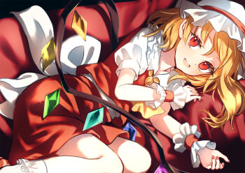 1girl blonde_hair commentary couch crystal_wings dise_(psychoro) fang flandre_scarlet hat highres looking_at_viewer lying medium_hair mob_cap nail_polish on_couch on_side parted_lips red_eyes red_nails red_skirt red_vest shirt short_sleeves side_ponytail skin_fang skirt smile solo touhou vampire vest white_shirt wings wrist_cuffs