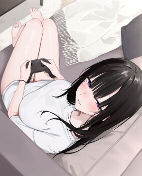 1girl barefoot black_hair breasts closed_mouth commentary_request controller couch feet from_above from_side game_controller highres holding holding_controller holding_game_controller indoors large_breasts long_hair looking_at_viewer mole mole_under_eye mole_under_mouth nenight no_pants original purple_eyes shirt short_sleeves sideways_glance smile solo toes white_shirt