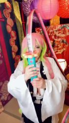 1girl animated braid breasts cleavage cosplay female_focus gradient_hair highres holding holding_sword holding_weapon japanese_(nationality) kanroji_mitsuri kanroji_mitsuri_(cosplay) kimetsu_no_yaiba large_breasts looking_at_viewer model multicolored_hair open_mouth photo_(medium) real_life shibuya_kaho smile solo sound standing standing_on_one_leg sword tongue tongue_out twin_braids twintails video weapon