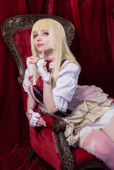 1girl blonde_hair chair cosplay cosplay_photo dress emilie_de_rochefort emilie_de_rochefort_(cosplay) fingerless_gloves gloves highres long_hair looking_at_viewer mirikashi_cosplay photo_(medium) real_life short_sleeves tekken tekken_8 thighs