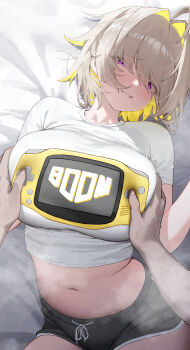 1girl absurdres ahoge bed_sheet black_shorts blonde_hair blush breasts closed_mouth colored_inner_hair commentary elegg_(nikke) fang fang_out game_boy_advance game_boy_advance_(original) goddess_of_victory:_nikke groping hair_intakes handheld_game_console highres large_breasts looking_at_viewer lying medium_hair multicolored_hair navel nikku_nana on_back purple_eyes shirt short_sleeves shorts smile solo_focus steaming_body stomach symbol-only_commentary thighs white_shirt
